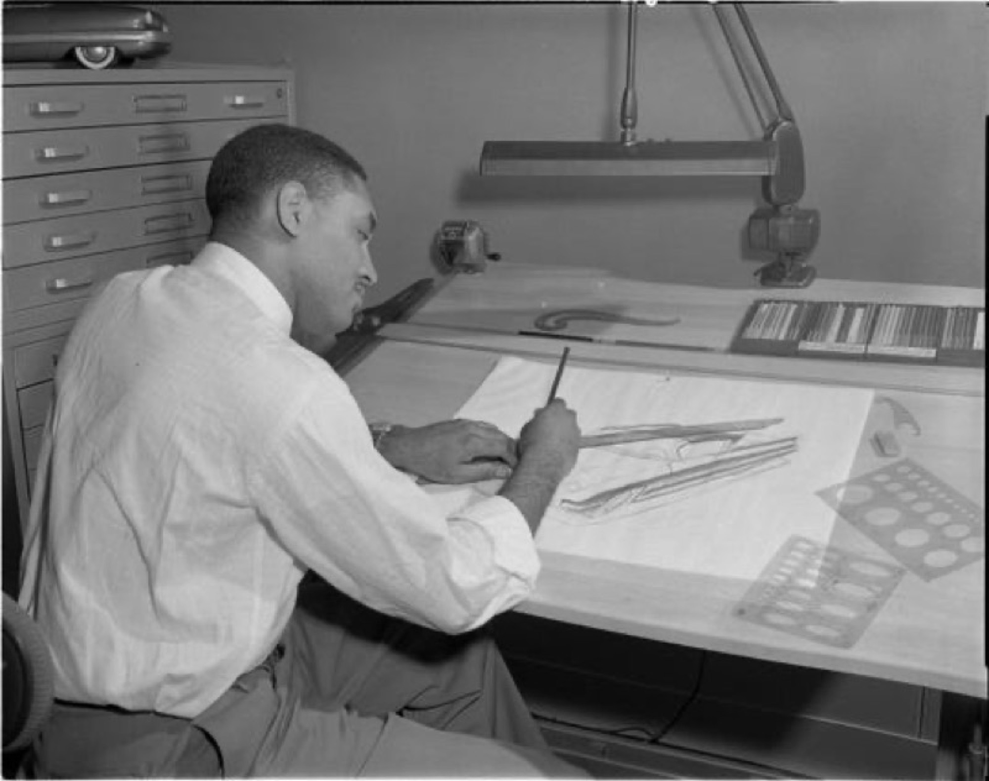 McKinley Thompson Jr., Ford's first African American automobile designer, working at a drafting table in Ford's Advanced Styling Studio