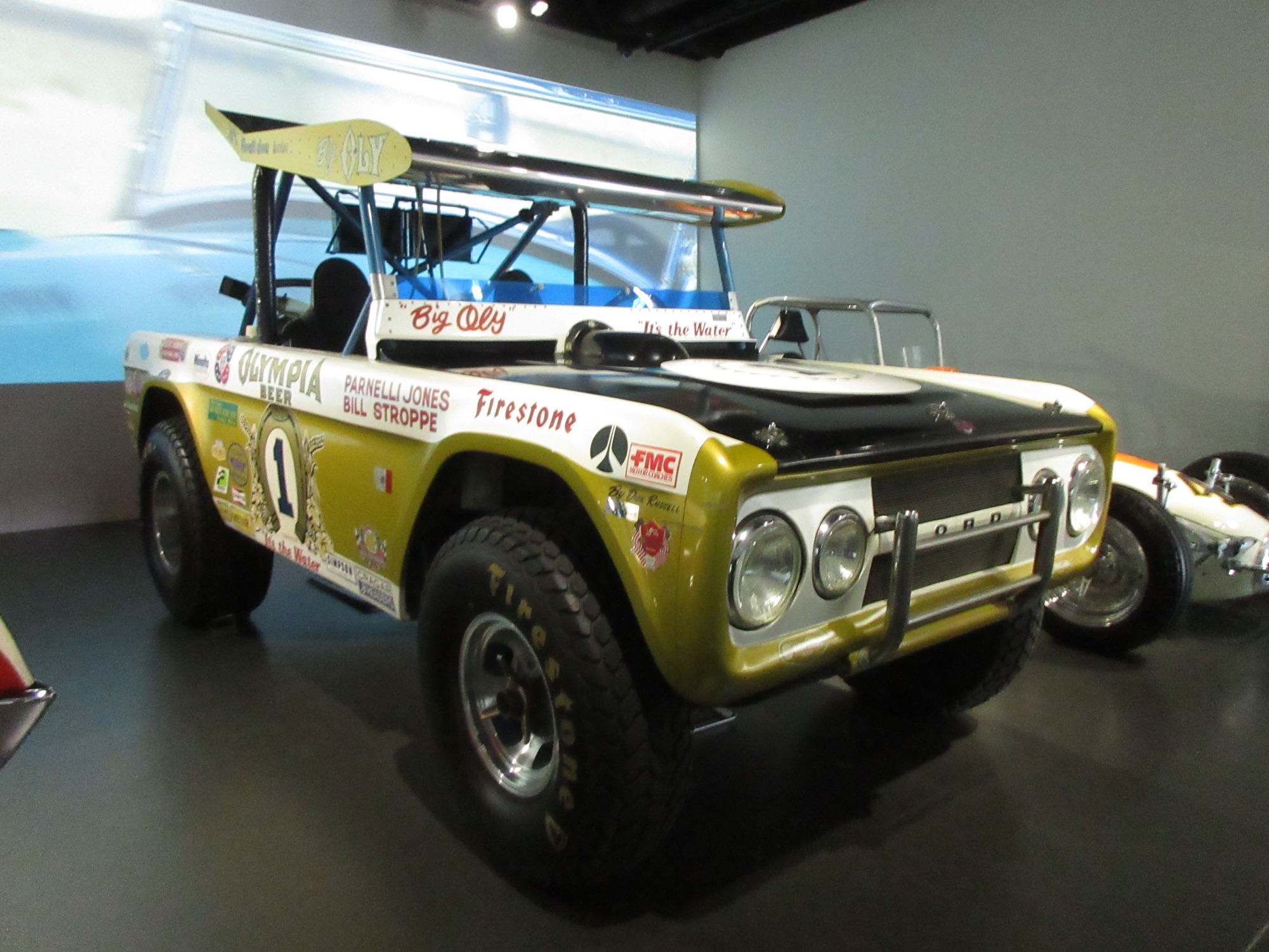The "Big Oly" Vel's Parnelli Jones/Bill Stroppe Ford Bronco race truck (Olympia Beer/Firestone/FMC livery, "It's the Water," race number 1), on display at the Petersen Automotive Museum, Los Angeles